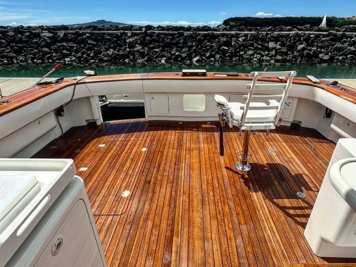 Boat teak deck before restoration — weathered and gone dark